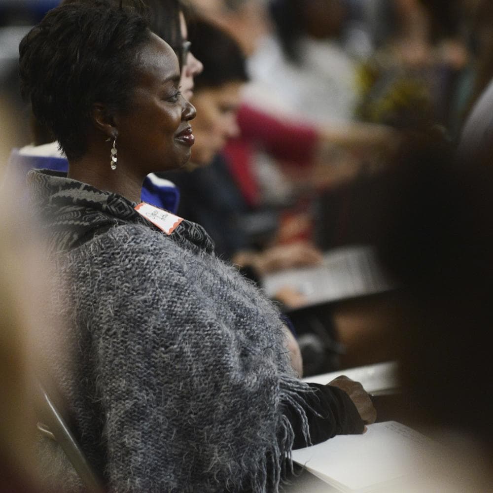 Woman sitting in a conference audience