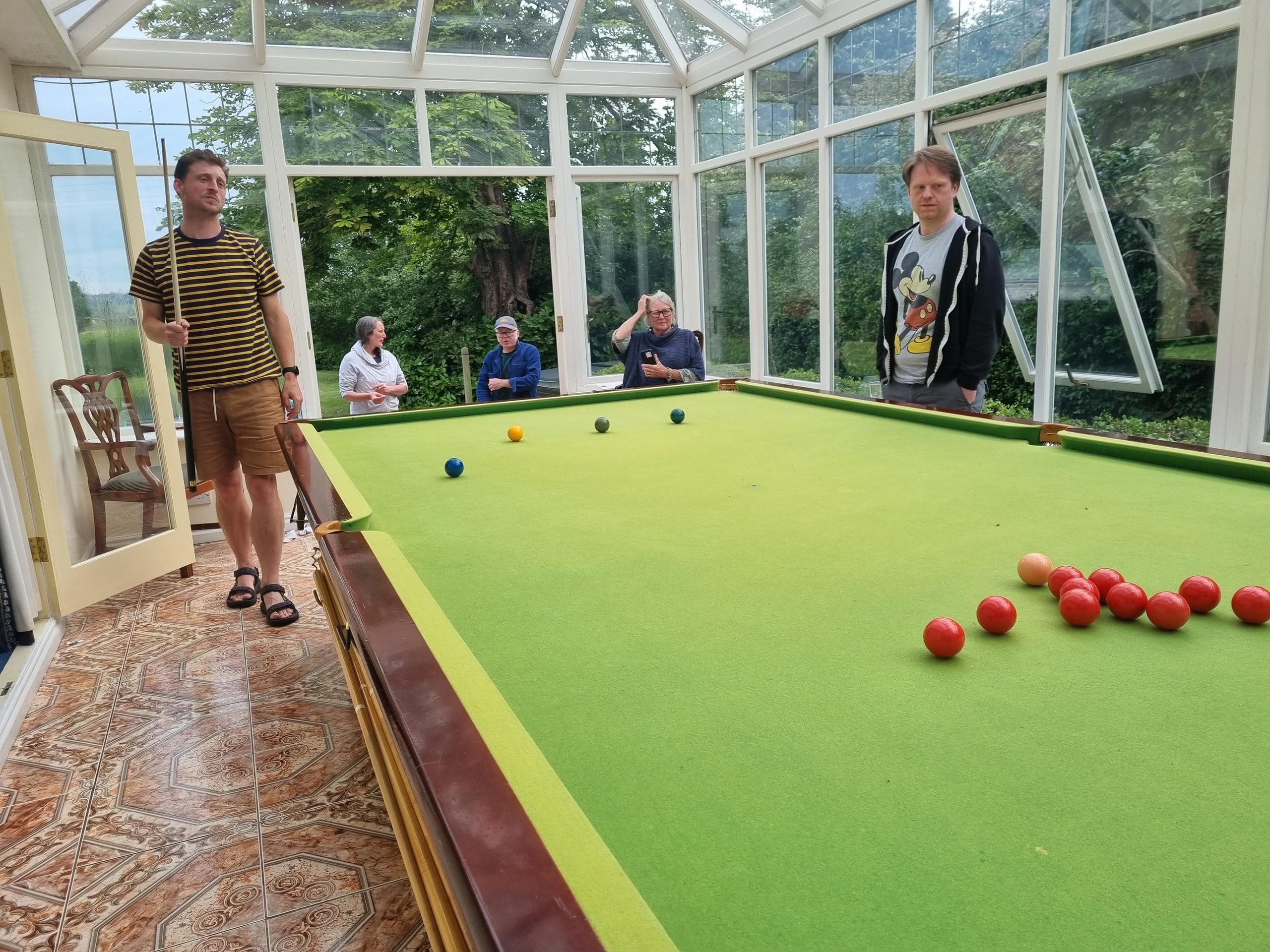 James and Luke playing snooker with the an audience of Maria, Chris and Linda