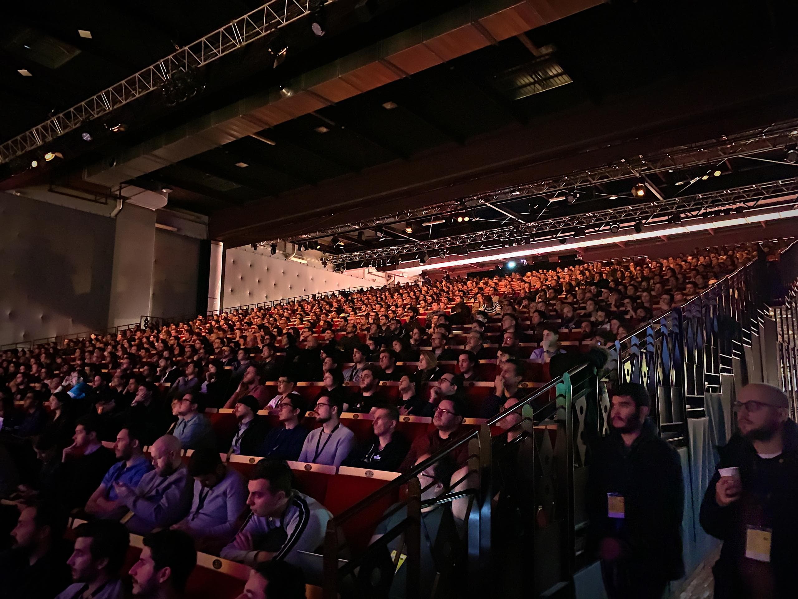 A photo showing a packed auditorium for dotJS