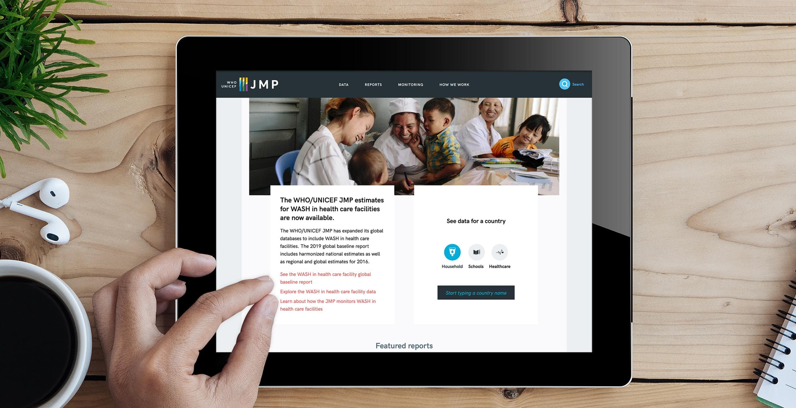 Image of ipad on table displaying the JMP homepage