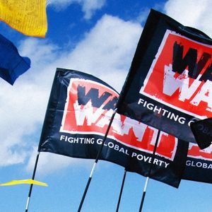 Image of War on Want banners flying in the breeze alongside Tibetan prayer flags