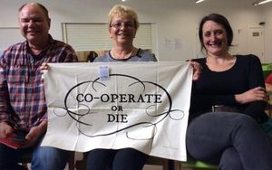 Displaying the "Cooperate or Die" Tea-towel
