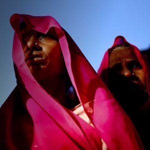 two women in brightly coloured head scarves