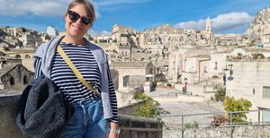 Raquel on holiday in sun glasses at the top of some stairs overlooking a town